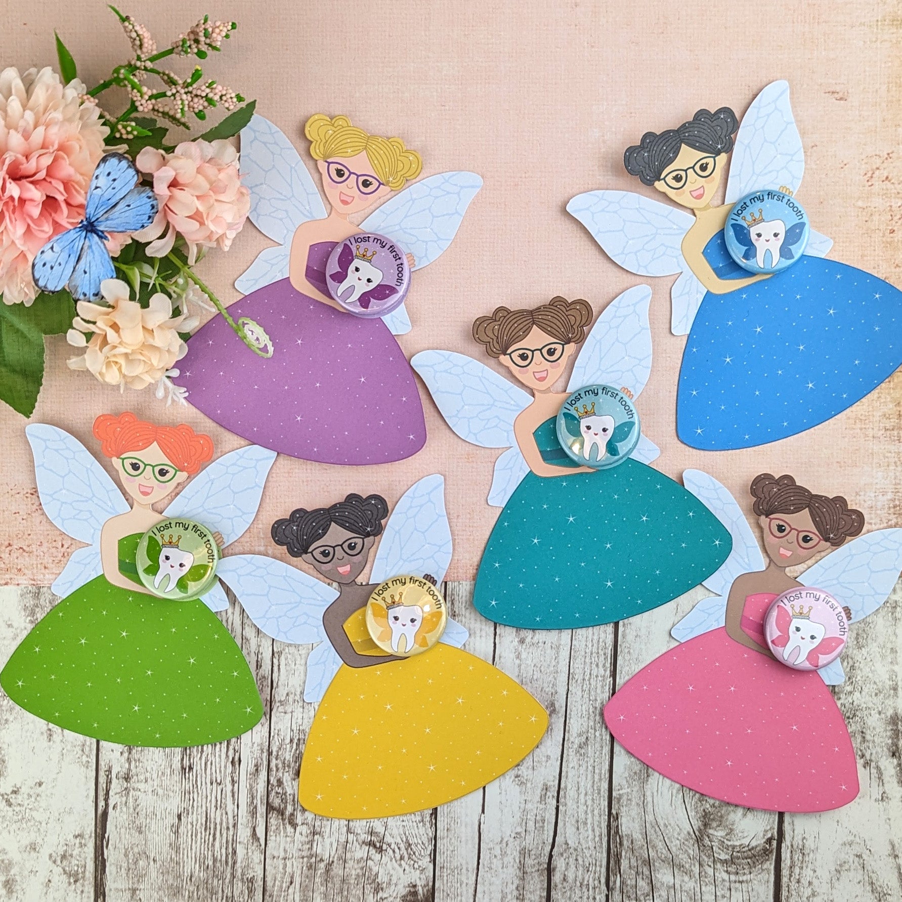 Six different fairies with matching badges. The badge design has a tooth with wings and a crown and the words 'I lost my first tooth'.