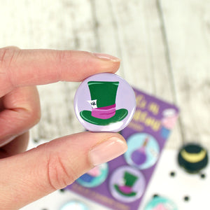 A green Mad Hatters hat with a purple band and the 10/6 tag