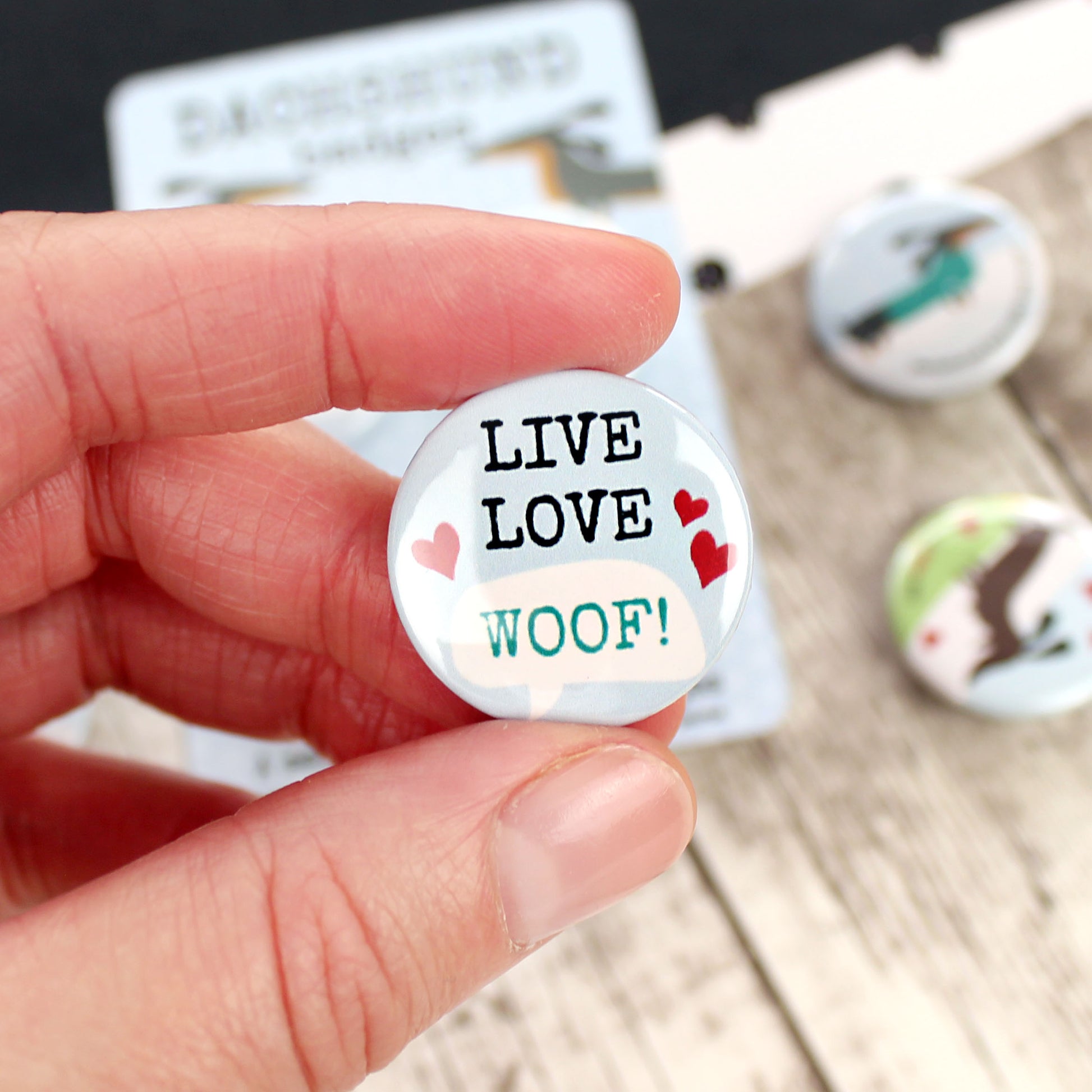 The words ‘LIVE LIFE WOOF’ with some hearts.